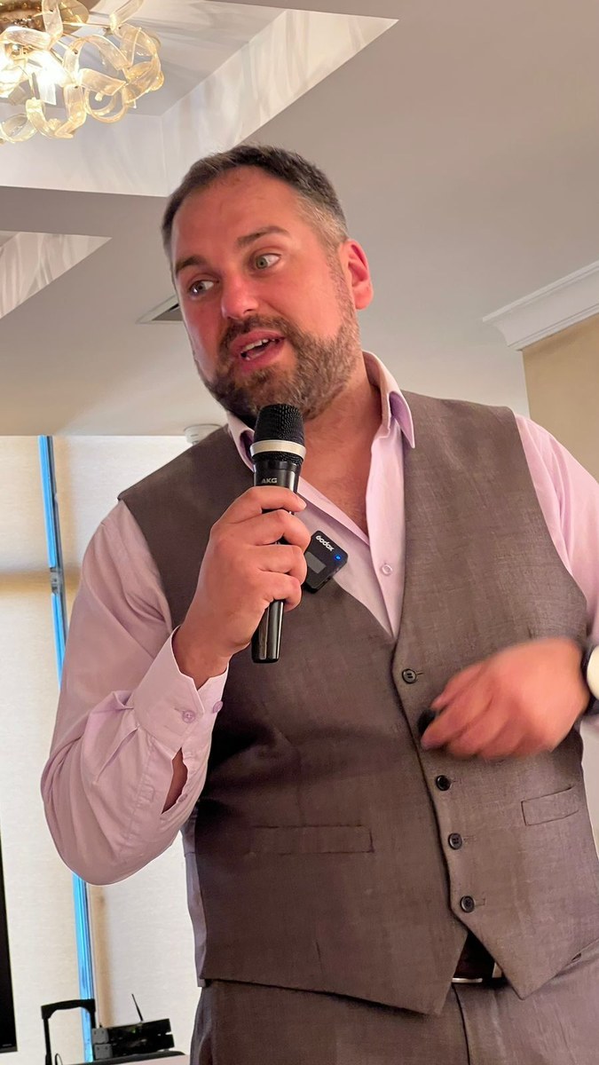 Rida speaking with microphone